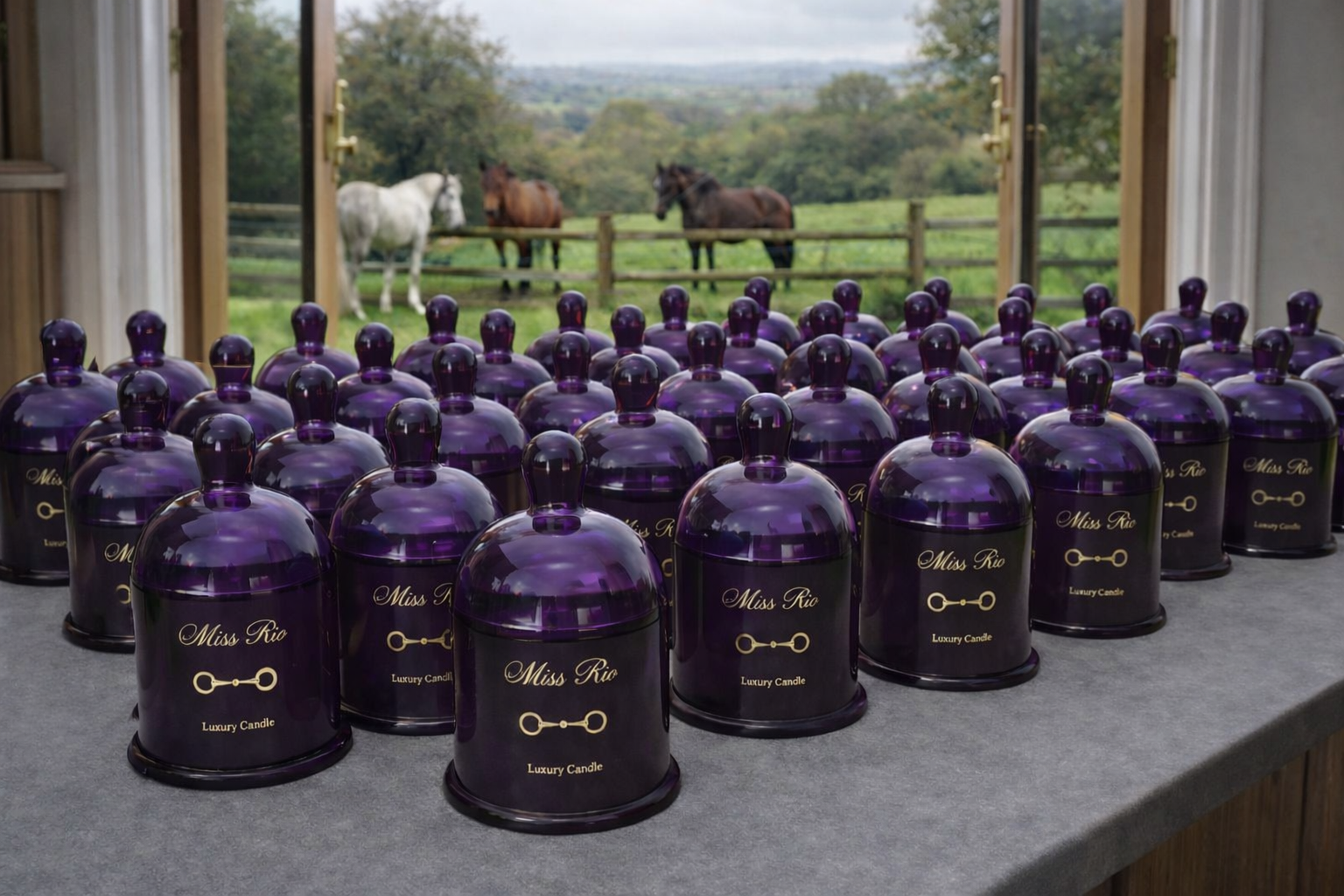 Miss Rio luxury candles displayed with equestrian countryside view