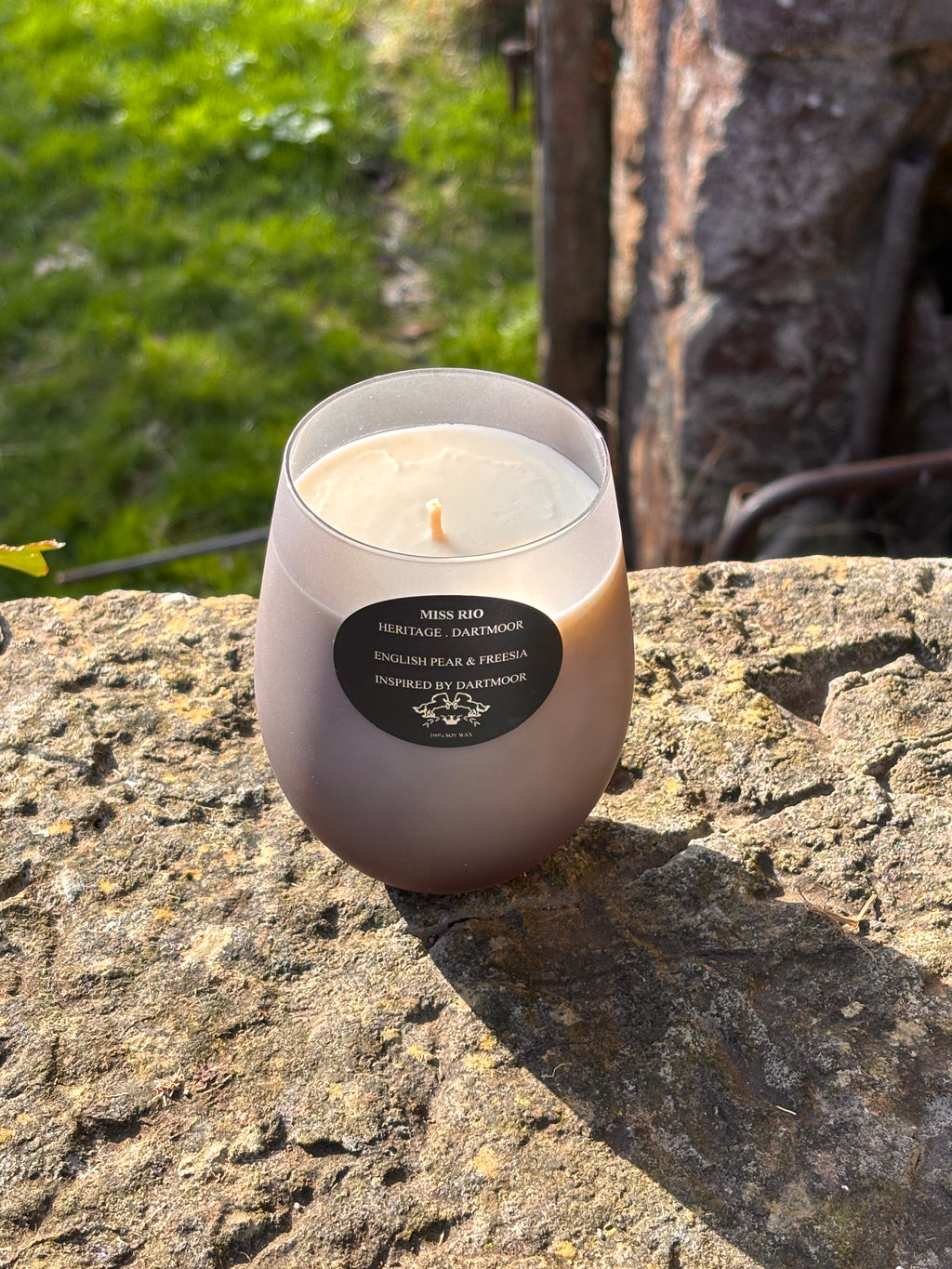 Miss Rio candle on a luxury granite step the scent English Pear & Freesia in a frosted grey vessel 