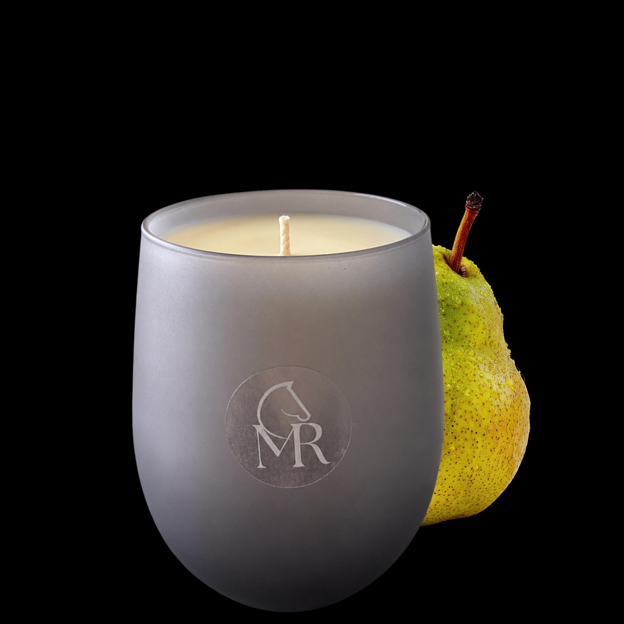 Miss Rio English Pear & Freesia luxury soy candle displayed with a fresh pear, inspired by Dartmoor and hand-poured in Devon.