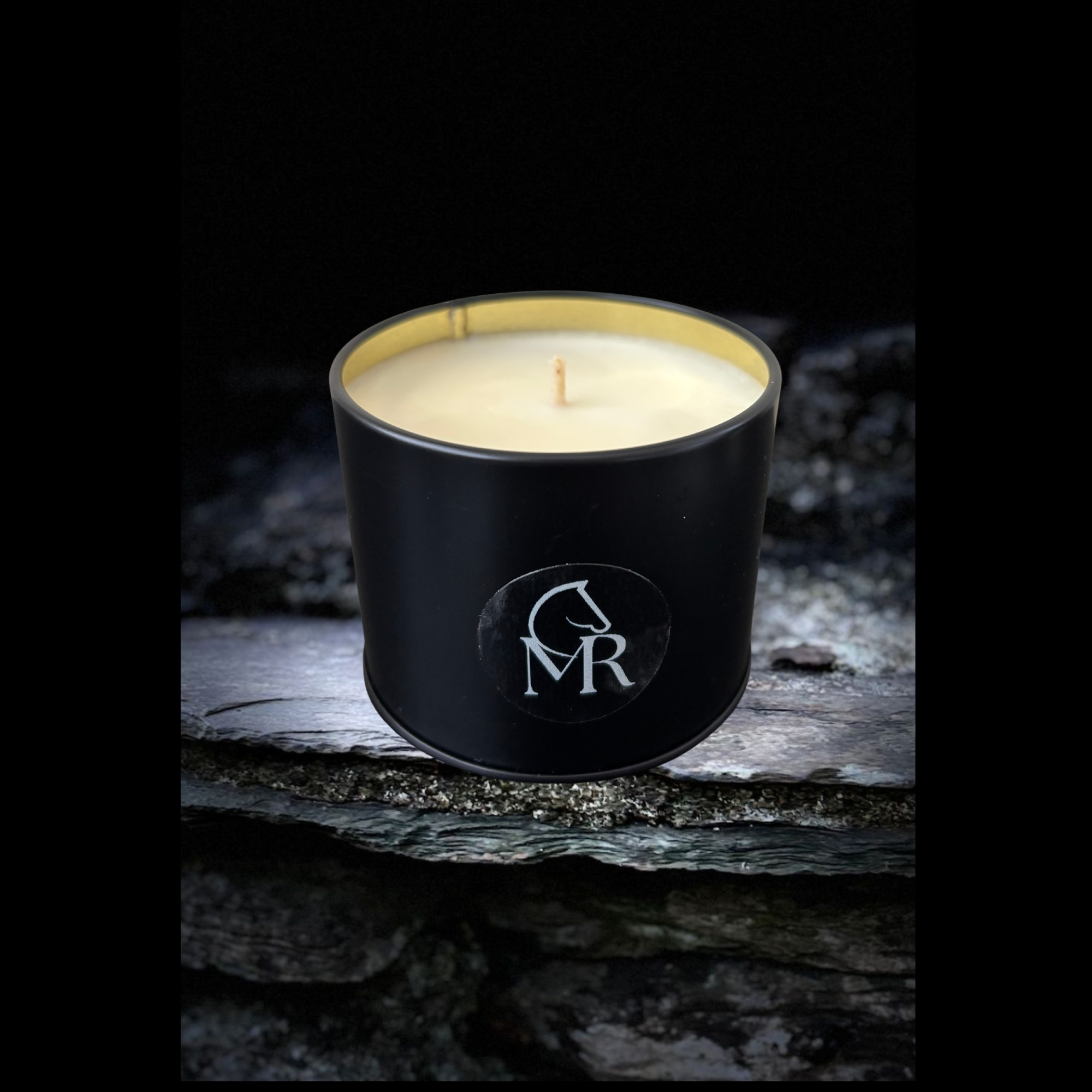 Miss Rio English Pear & Freesia luxury soy candle displayed on Dartmoor stone, inspired by the wild beauty of the Devon countryside.