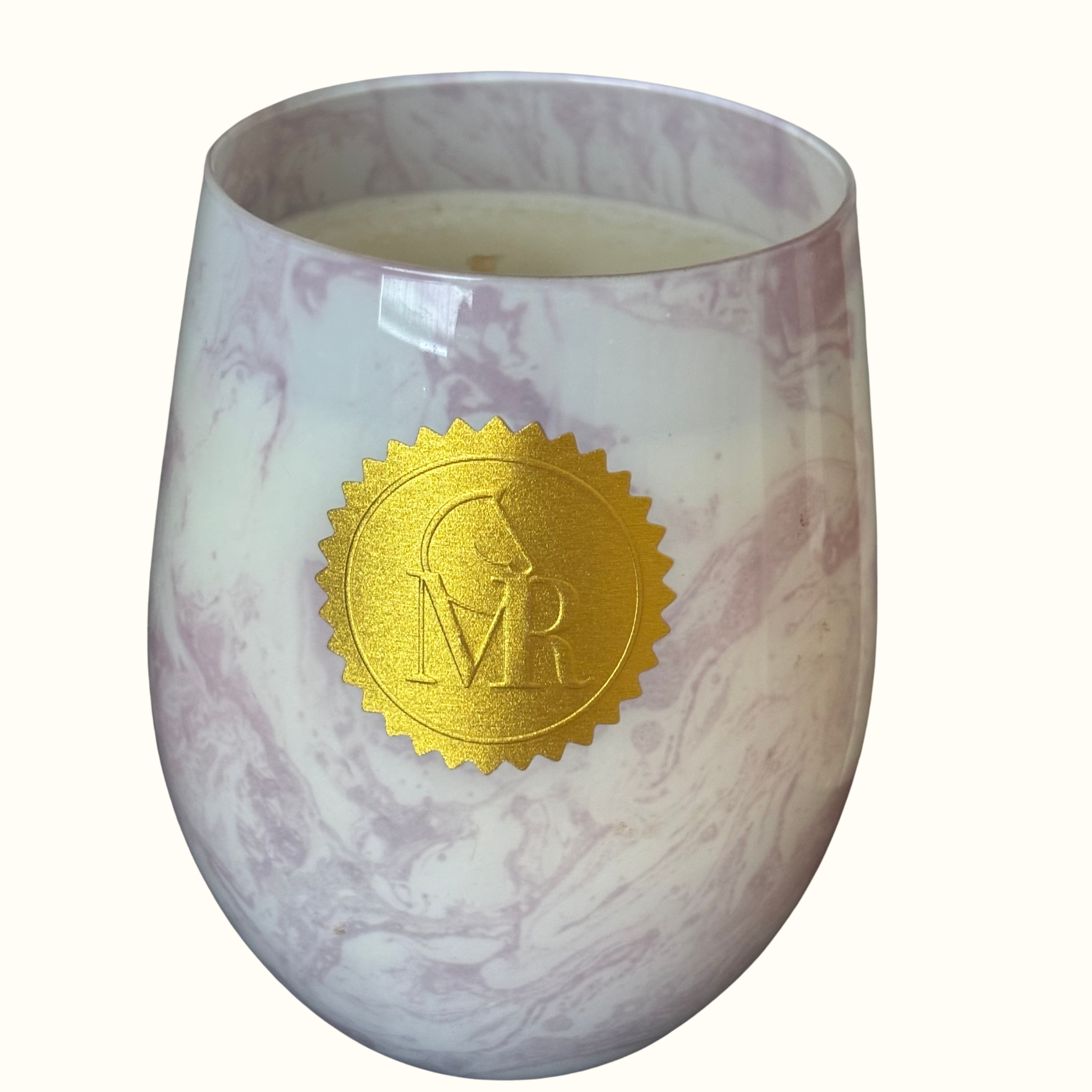 English Pear & Freesia scented luxury soy candle in a pink and white marbled glass vessel, styled in a rustic pear orchard with fresh pears and countryside surroundings