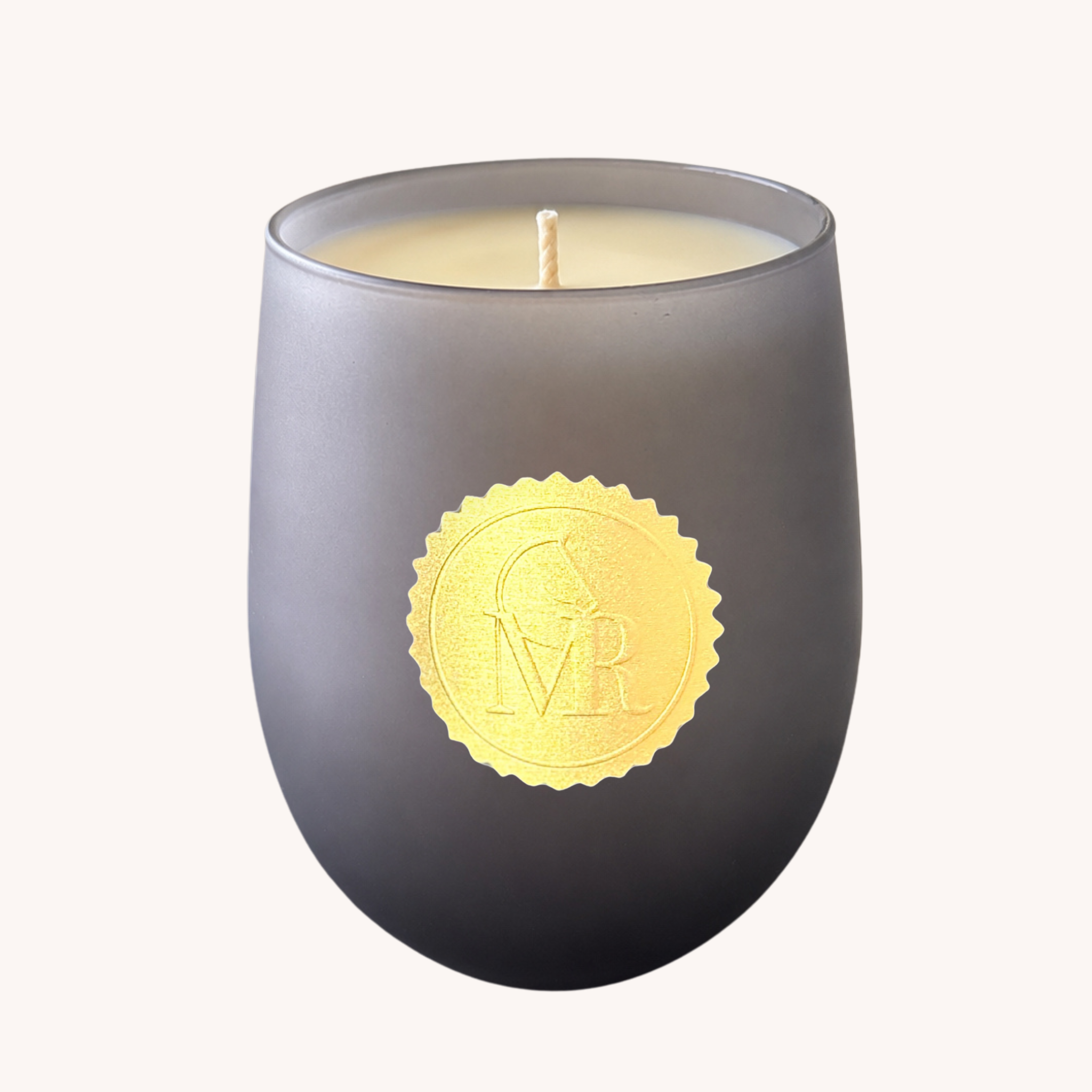 Luxury dark grey Miss Rio candle with cream wax and gold MR seal, photographed against a clean off-white background