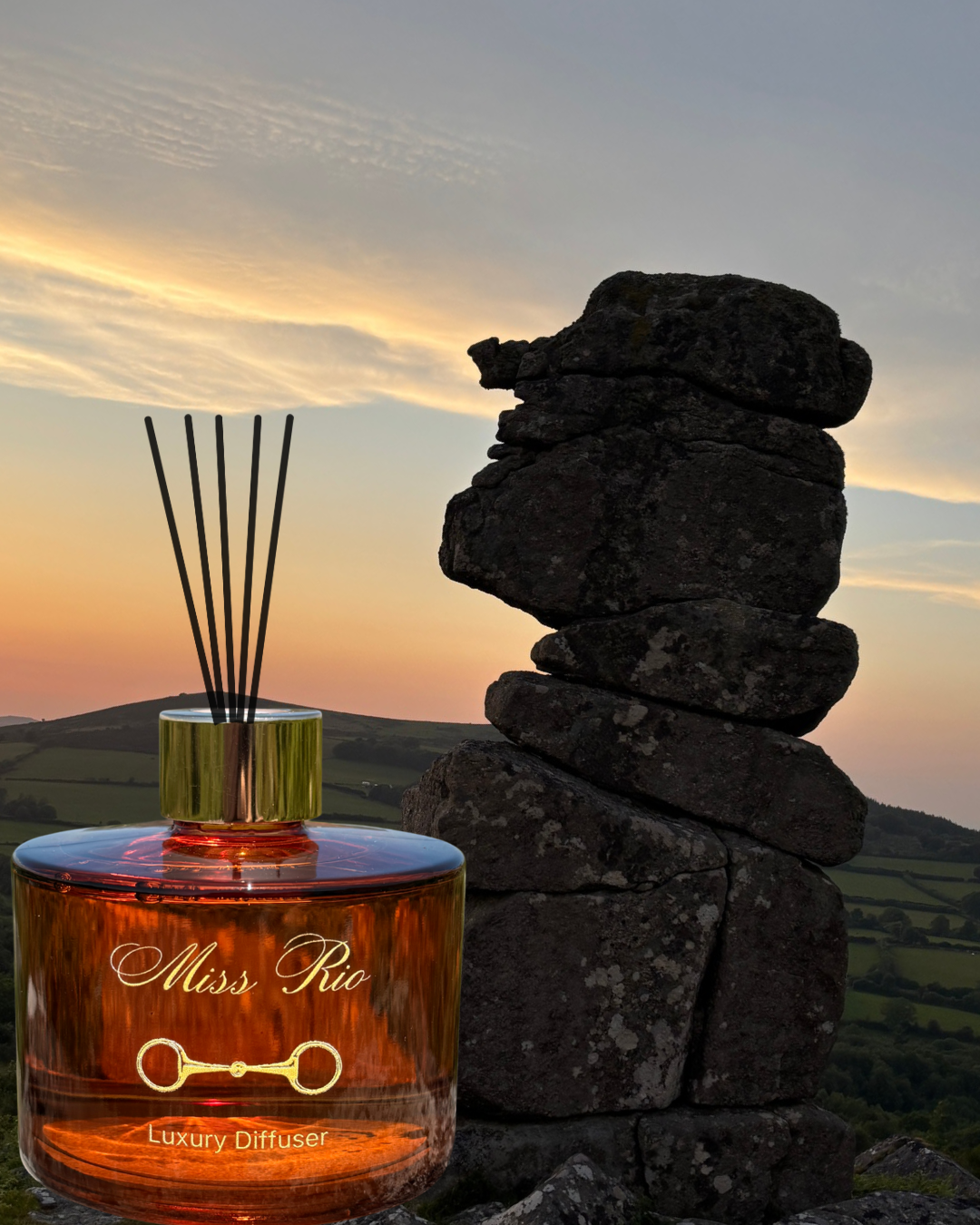 Miss Rio luxury diffuser with sunset and stacked stones in the background